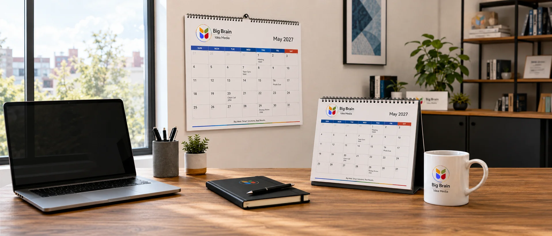 Big Brain Idea Media branded 2027 monthly wall calendar and desk calendar in a modern office workspace.